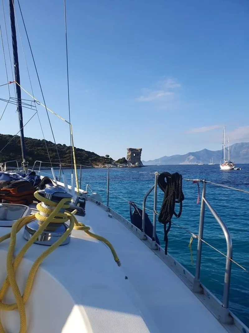 Eridu sailing yacht in front of the Tower of Mortella at the entrance to the Gulf of Saint-Florent