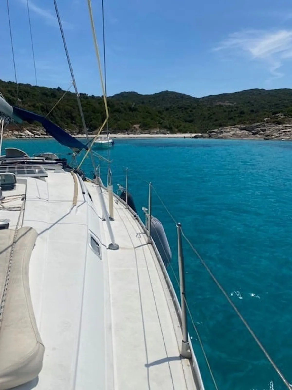 Ghignu beach seen from the deck of a sailing yacht at anchor, a wild cove in the Agriates desert